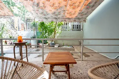a patio with a table and chairs on a balcony at Petrαlonα 1-Bdr cοmfort, neαr Metro by Traser in Athens