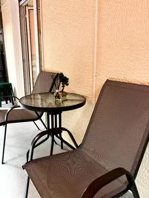 a table with two chairs and a table with a plant on it at Cozy Apartment in Central Athens in Athens