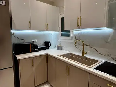 a kitchen with white cabinets and a sink at Cozy Apartment in Central Athens in Athens