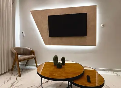 a living room with a table and a tv at Cozy Apartment in Central Athens in Athens