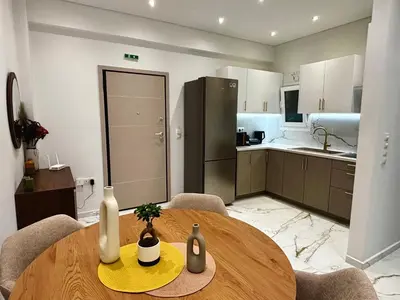 a kitchen and dining room with a table in a room at Cozy Apartment in Central Athens in Athens