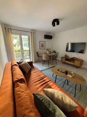 a living room with a couch and a table at MediTerra Stay Voula Beach in Athens