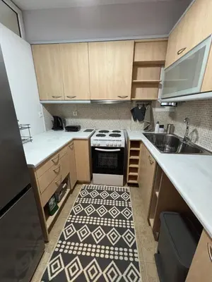a small kitchen with a stove and a sink at MediTerra Stay Voula Beach in Athens