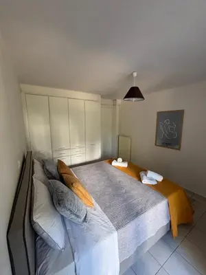 a bedroom with a large bed with pillows at MediTerra Stay Voula Beach in Athens