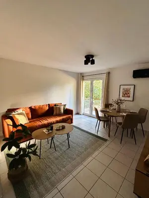a living room with a couch and a table at MediTerra Stay Voula Beach in Athens