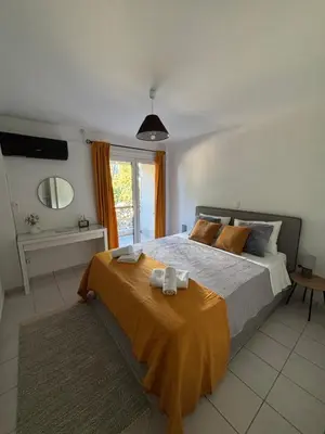 a bedroom with a large bed and a mirror at MediTerra Stay Voula Beach in Athens