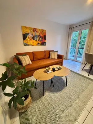 a living room with a couch and a table at MediTerra Stay Voula Beach in Athens