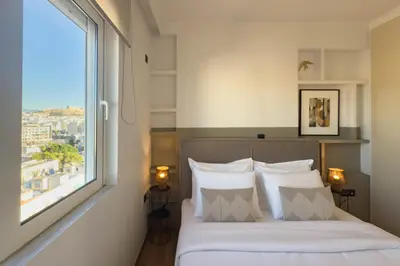 a bedroom with a bed with a large window at Acropolis Sky Retreat Jacuzzi & 3BR Maisonette in Athens