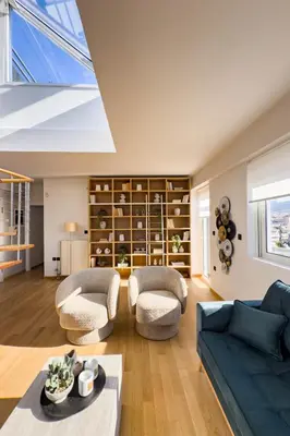 a living room with a blue couch and chairs at Acropolis Sky Retreat Jacuzzi & 3BR Maisonette in Athens