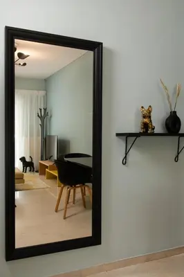 a mirror on a wall in a living room at Sea and City Voula Suite by First Class Properties in Athens