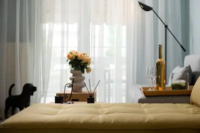 a living room with a couch and a vase of flowers at Sea and City Voula Suite by First Class Properties in Athens