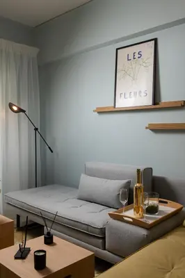 a living room with a couch and a table at Sea and City Voula Suite by First Class Properties in Athens