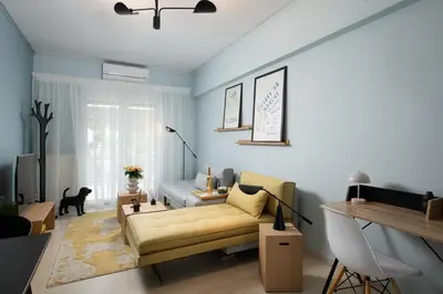 a living room with a yellow couch in front of a window at Sea and City Voula Suite by First Class Properties in Athens