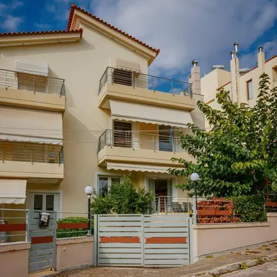 a house with a white fence in front of it at Athens Riviera Luxury Voula Residence in Athens