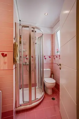 a pink bathroom with a shower and a toilet at Athens Riviera Luxury Voula Residence in Athens