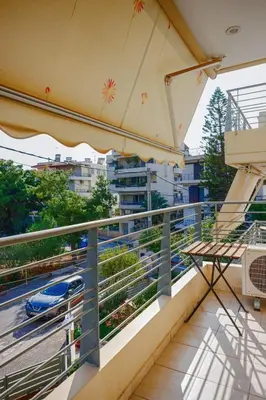 a balcony with a view of a train at Athens Riviera Luxury Voula Residence in Athens