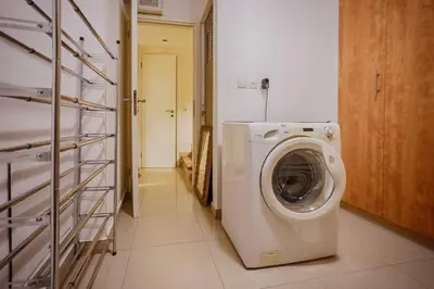 a laundry room with a washing machine in a bathroom at Athens Riviera Luxury Voula Residence in Athens