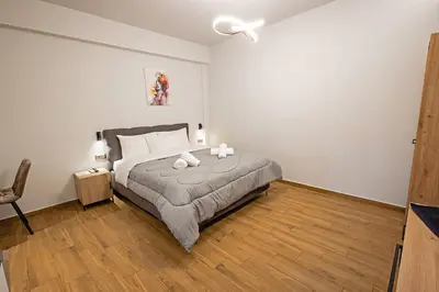 a bedroom with a bed with two candles on it at Gina's Apartments in Spáta