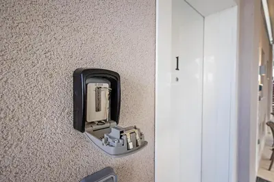 a soap dispenser on a wall next to a door at Gina's Apartments in Spáta