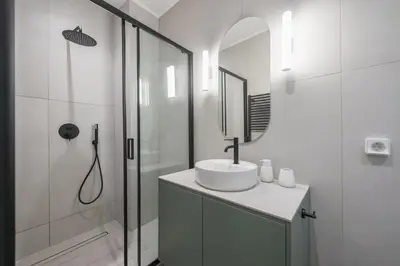 a white bathroom with a sink and a shower at Athens Lyrics in Athens