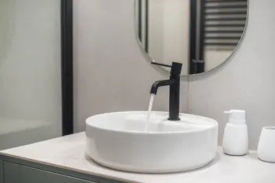 a white sink with a faucet on a counter in a bathroom at Athens Lyrics in Athens