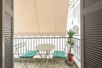 a balcony with a table and two chairs and a table at Athens Lyrics in Athens