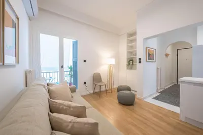 a white living room with a couch and a table at Athens Lyrics in Athens