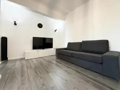 a living room with a couch and a flat screen tv at Glyfada Center Apt 11 in Athens