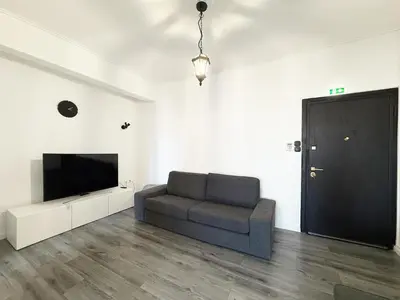 a living room with a couch and a flat screen tv at Glyfada Center Apt 11 in Athens
