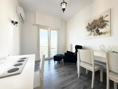 a kitchen and dining room with a table and chairs at Glyfada Center Apt 11 in Athens