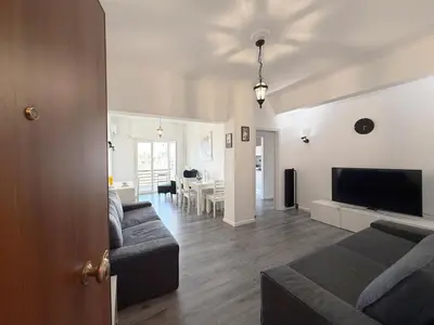 a living room with a couch and a flat screen tv at Glyfada Center Apt 11 in Athens