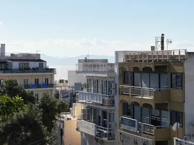 a group of buildings with the ocean in the background at Glyfada Center Apt 11 in Athens