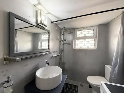 a white bathroom with a sink and a mirror at Glyfada Center Apt 11 in Athens