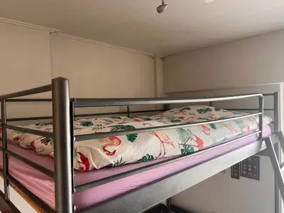 a bunk bed with a floral blanket on it at Terrace View Studio in Athens