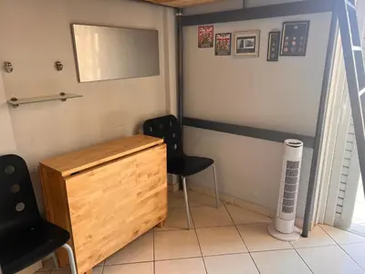 a room with two chairs and a wooden desk at Terrace View Studio in Athens