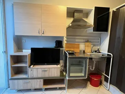 a small kitchen with a tv and a counter at Terrace View Studio in Athens