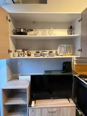 a kitchen with a shelf with dishes on it at Terrace View Studio in Athens