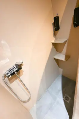 a bathroom with a towel rack on the wall at Kallithea Cozy Stonewall Studios in Athens