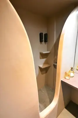 a bathroom with a circular mirror and a sink at Kallithea Cozy Stonewall Studios in Athens