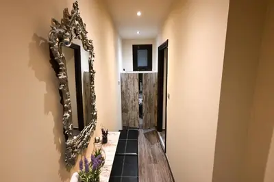 a hallway with a mirror on the wall at Kallithea Cozy Stonewall Studios in Athens