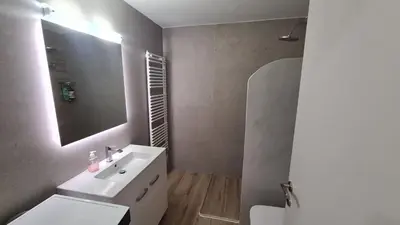 a bathroom with a white sink and a mirror at Stella House near Metropolitan & Holargos Metro Station in Athens