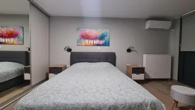 a bedroom with a bed and two paintings on the wall at Stella House near Metropolitan & Holargos Metro Station in Athens