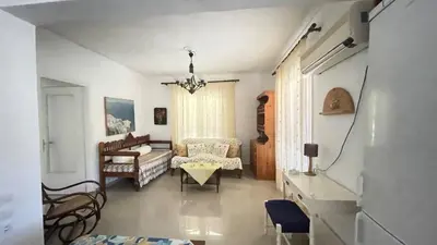 a living room with a couch and a table at Sunny with terrace around, sea view, 65 sqm in Saronida