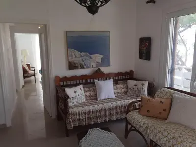 a living room with a couch and two chairs at Sunny with terrace around, sea view, 65 sqm in Saronida