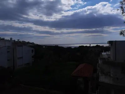 a view of the ocean from a city at Sunny with terrace around, sea view, 65 sqm in Saronida
