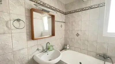 a bathroom with a sink and a tub and a mirror at Sunny with terrace around, sea view, 65 sqm in Saronida