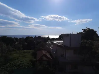 an overhead view of a city with trees and buildings at Sunny with terrace around, sea view, 65 sqm in Saronida