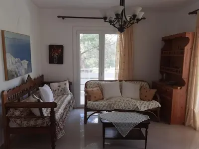 a living room with two couches and a window at Sunny with terrace around, sea view, 65 sqm in Saronida