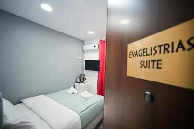 a hotel room with a bed and a sign that reads breakfast suite at Evaggelistrias 22 Suite by Zeus Suites in Athens