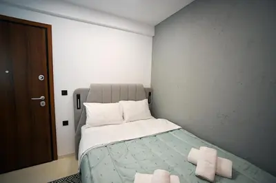 a bedroom with a bed with two towels on it at Evaggelistrias 22 Suite by Zeus Suites in Athens